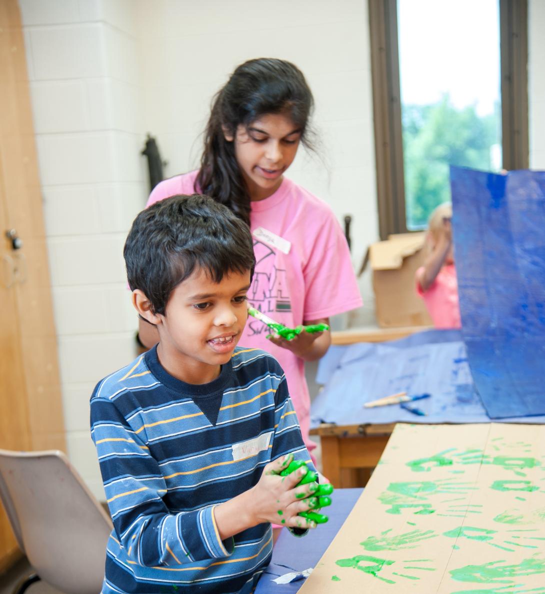 Youth working with clay at art camp