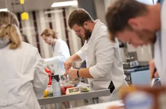 student preparing food in dietetics lab class