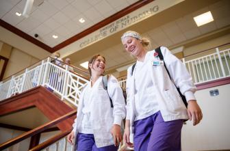 nursing students walking down stairs at the College of Nursing
