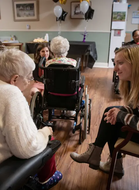 AU Student talking with resident at Good Shepherd