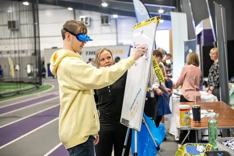 impairment goggles station at 2025 Junior Achievement Inspire event