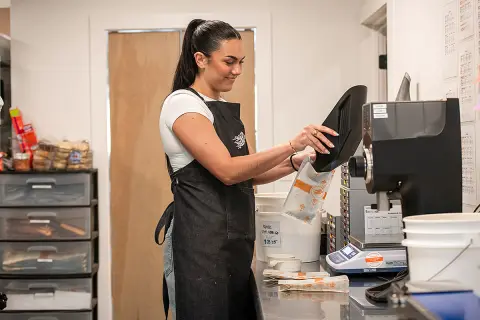 Hayley Smith '25 fills a Goldberry Roasting coffee bag