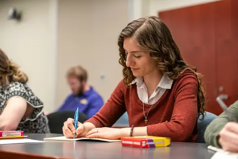 Bethany Graham, a 2025 graduate of the Physician Assistant program, journals during a workshop in the Healer's Art Course