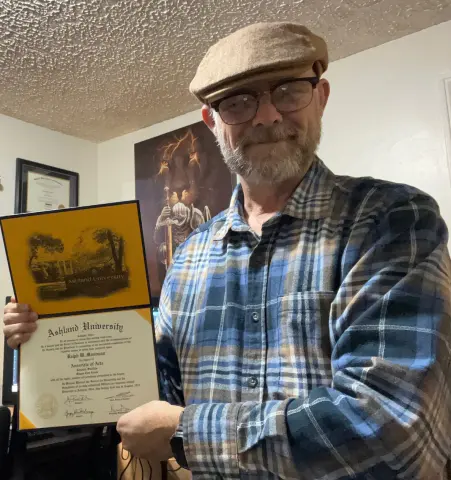 Ralph Moorman holding AU diploma