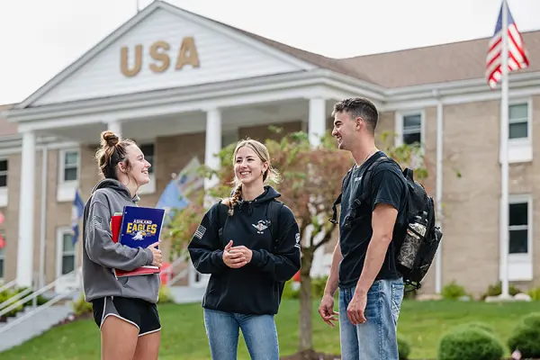 A group of military-connected students talking outside the USA House