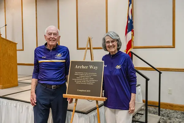 Bob and Jan Archer pose with the plaque commemorating Archer Way