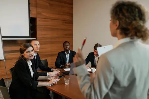 Team members meeting in an office, representing leadership, trust and managing workplace relationships.