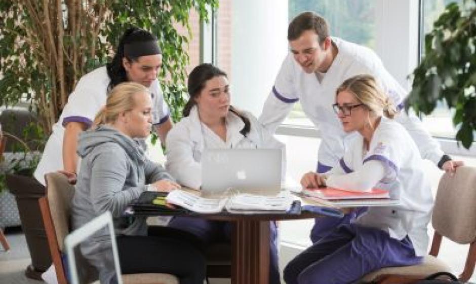 group of nursing students working around table