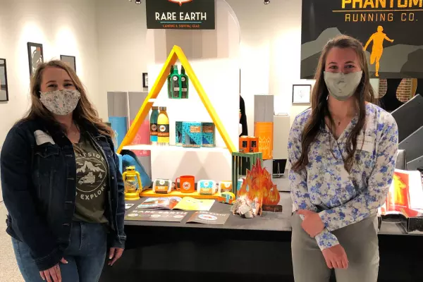 students displaying artwork