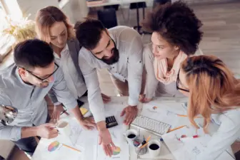 Group of people planning around a table.