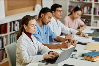 diverse group of young med students sitting in row