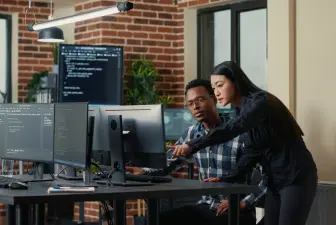 two software developers working at computer