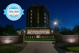 Archer Library at night with a College of Distinction badge laid over the photo