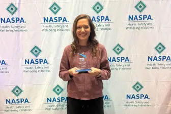 Janel Molnar with Outstanding Peer Education Advisor award at NASPA conference