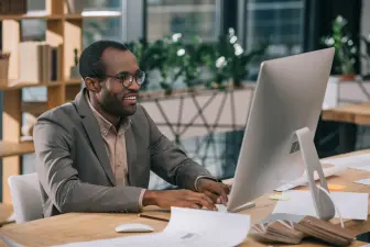 older man sitting at computer
