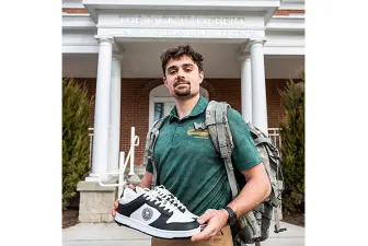 Kayin McDonald displays a sample of shoes given to veterans through the In a Soldier's Shoes Foundation