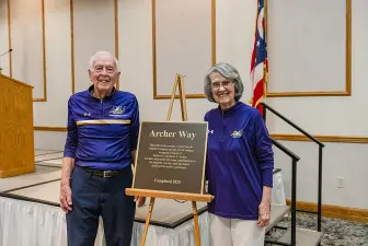 Bob and Jan Archer pose with the plaque commemorating Archer Way