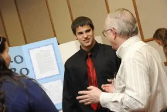 student and judge at science fair