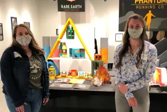 students displaying artwork