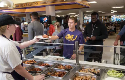 Student being served food in Convo