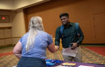 Student shaking hands with recruiter at job fair