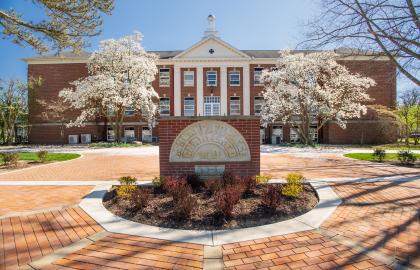 Founders Hall in the spring with Dogwood blossoms