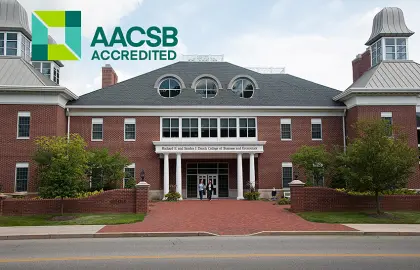 exterior photo of COBE with AACSB logo overlay