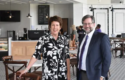 Jody Ruhl and President Jon Peede pose for a photo in the Lyceum Cafe
