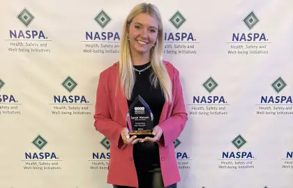 Sarah Watson poses with Outstanding Peer Educator Award