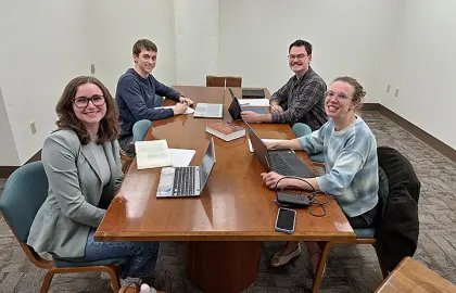 three students, professor presenting virtually
