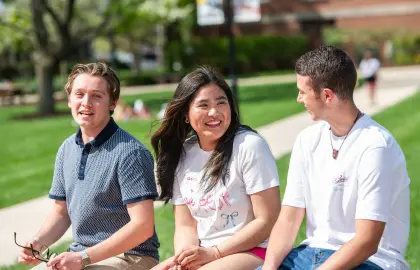 students sitting on bench outside