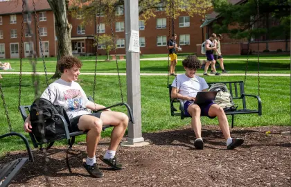 students relaxing on swings