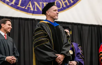 Mitch Metzger accepts Trustees' Distinguished Professor appointment at 2025 spring commencement ceremony.