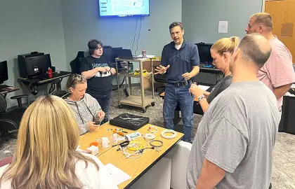 Workforce Development Program Director Joe Kacsandi with local educators at the Telecommunications Boot Camp