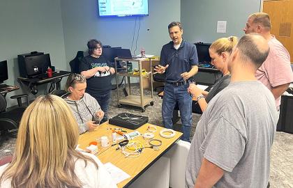 Workforce Development Program Director Joe Kacsandi with local educators at the Telecommunications Boot Camp