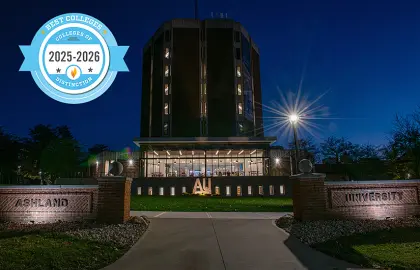 Archer Library at night with a College of Distinction badge laid over the photo