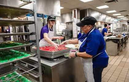 Workers decorating Christmas cookies