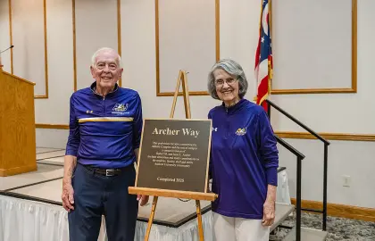 Bob and Jan Archer pose with the plaque commemorating Archer Way