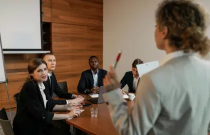Team members meeting in an office, representing leadership, trust and managing workplace relationships.