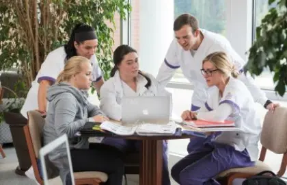 group of nursing students working around table
