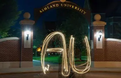 AU spelled out with sparkler in front of arch