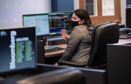 Business student investing on computer