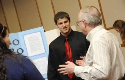 student and judge at science fair