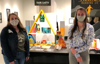 students displaying artwork