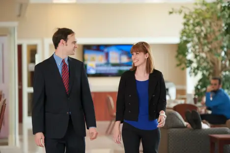 Nursing students in formal clothes in the walking in the lobby of the Dwight Schar College of Nursing and Health Sciences