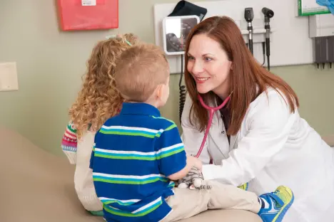 Nursing student examining children