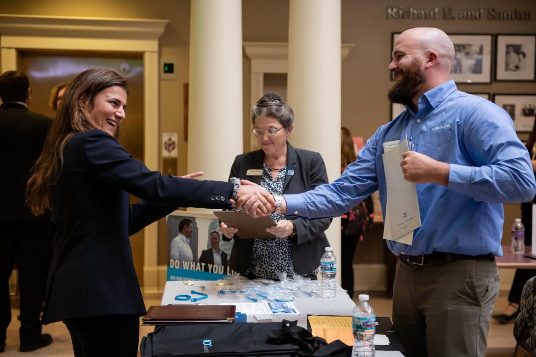 Student shaking hands with a recruiter