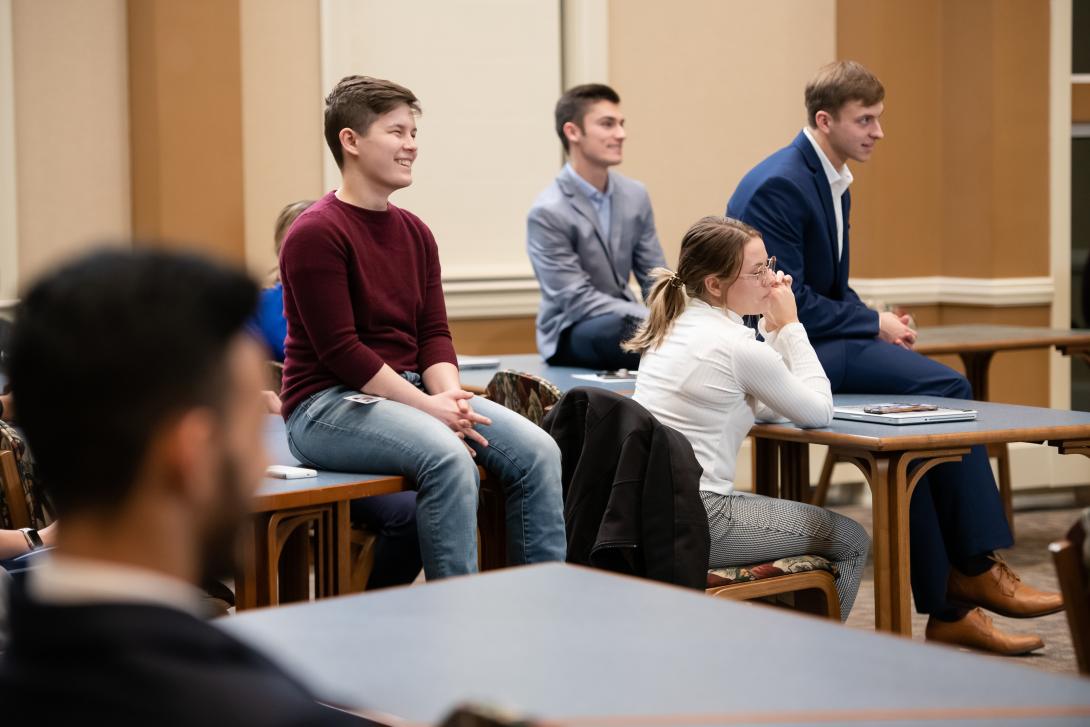 International Business students sitting on table during a presentation