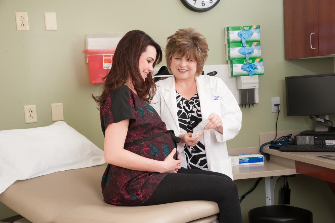 Nursing student examining a pregnant woman