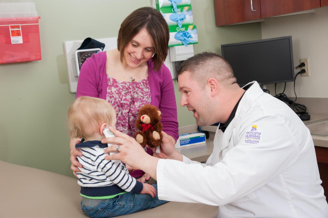 Nursing student examining a toddler